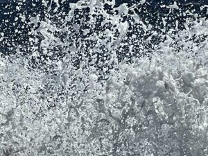 A close up of the water with white splashes